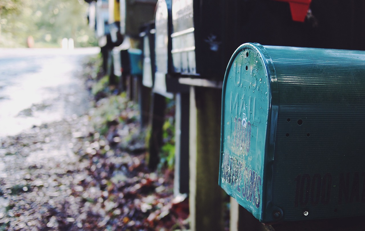 A row of colourful letterboxes along a road