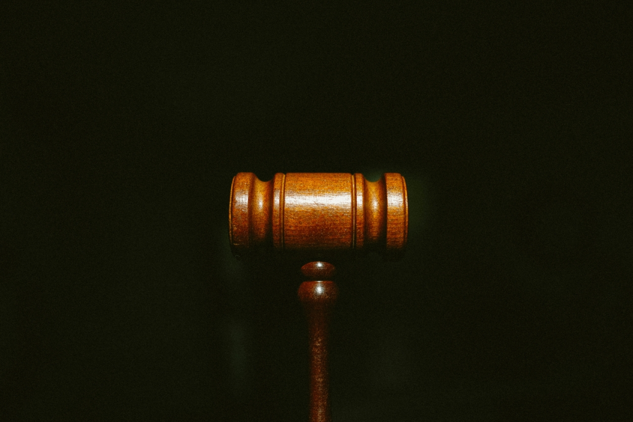 A wooden judge's gavel on a black background