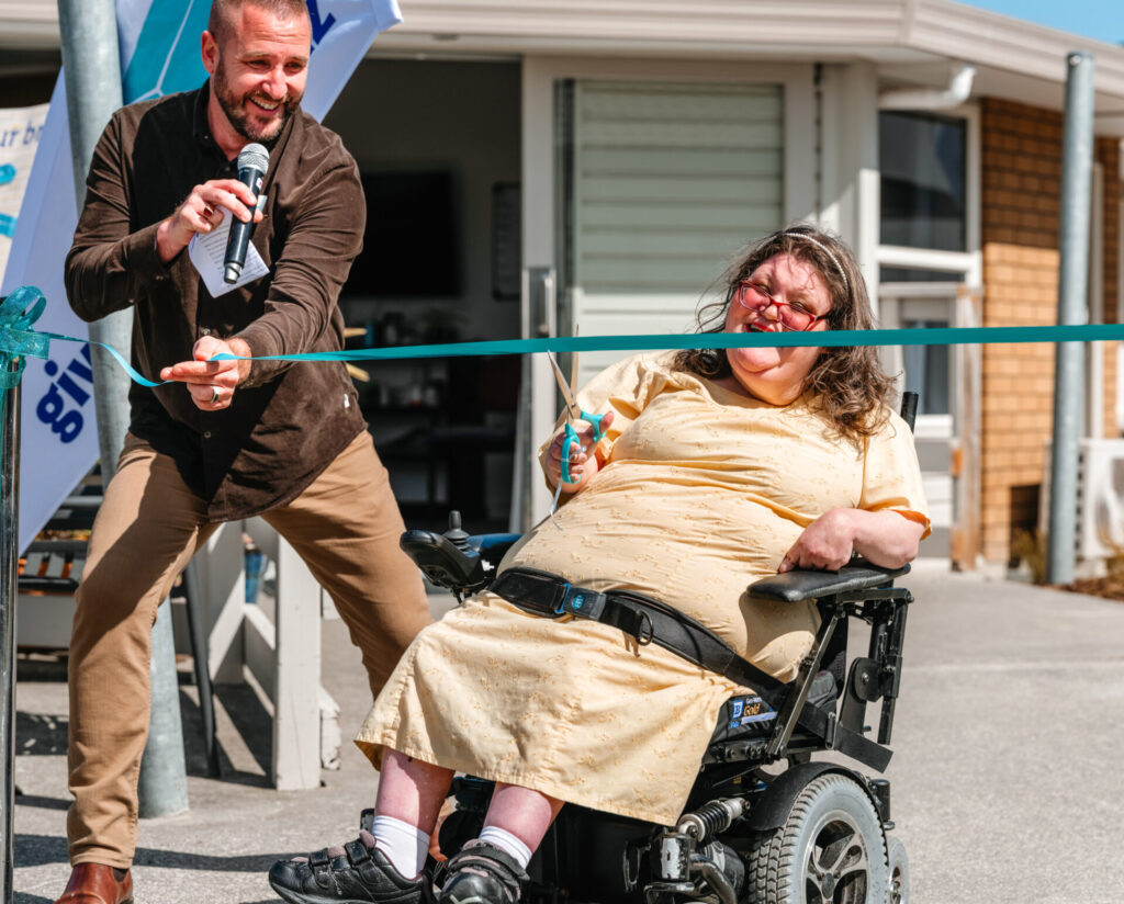 PSEC project team member Evelyn Churchill cutting ribbon at Rowan Apartments opening ceremony
