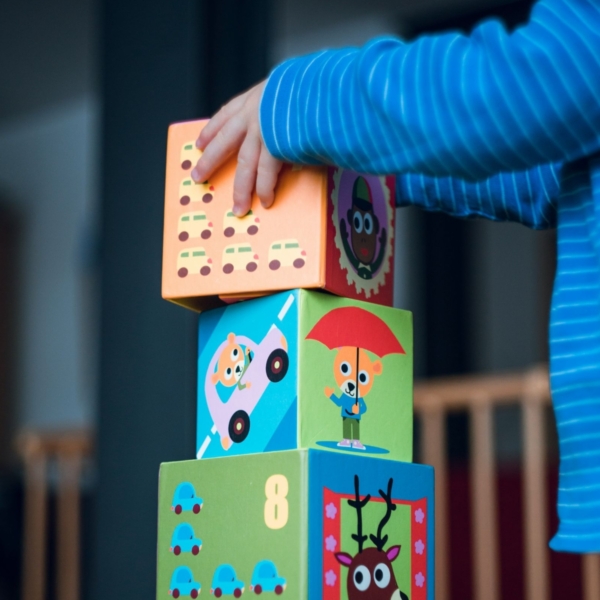 Child stacking colourful blocks