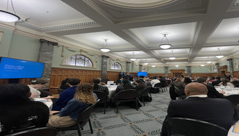 People sitting at tables in Parliament function room