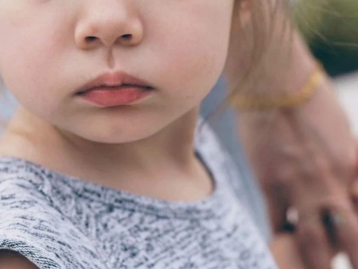 Cropped picture of child holding adult hand