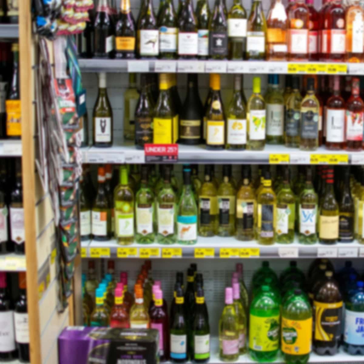 Bottles on shop shelves. Blurred