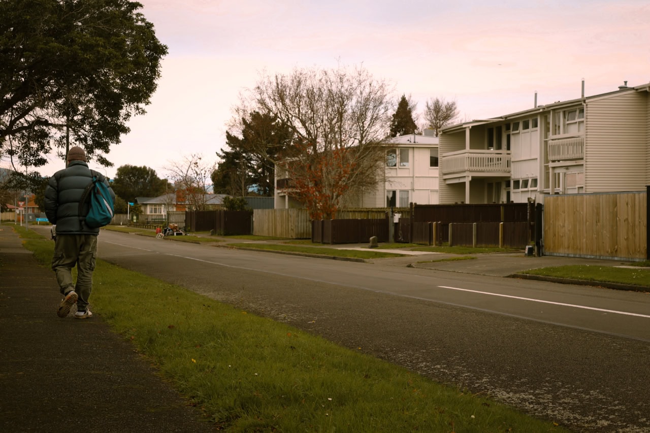 Person with backpack walking along street